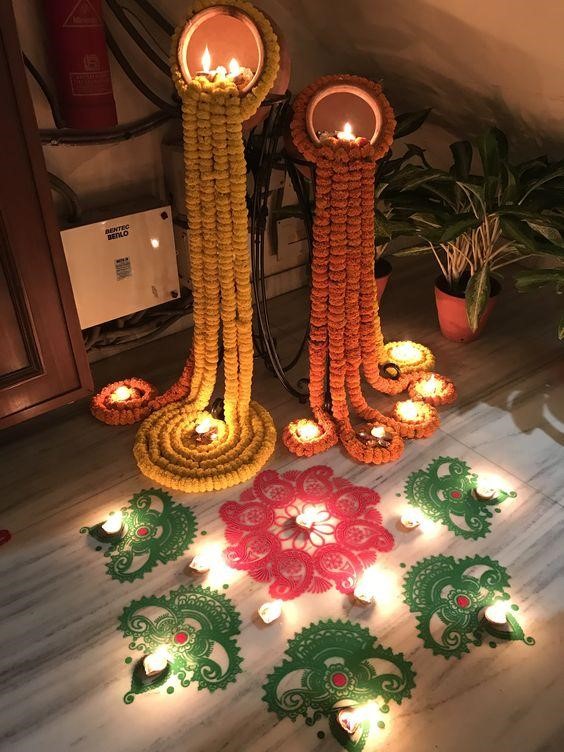 Pots with marigold flower rangoli